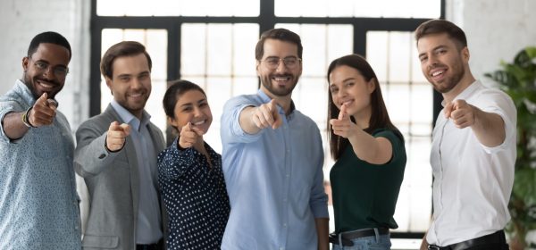 We need you. Happy confident professional group pointing finger at camera. Diverse millennial team of employees making choice, offering job, searching candidates for hiring. Head shot photo portrait